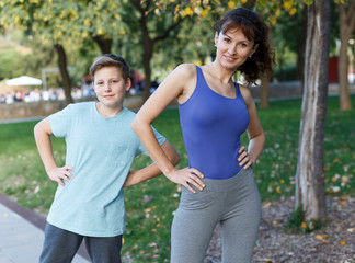 Mother and son stretching outdoors