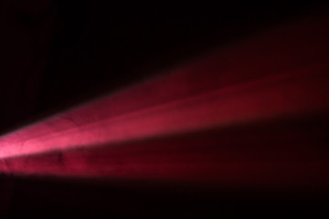 beautiful red color wide lens projector with light beam for movie and cinema at night . smoke texture spotlight . screening for multimedia black background .