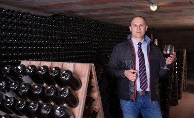 Winemaker proposing degustation of red wine