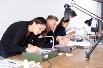 Female architect working on fret saw