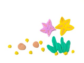 The beautiful underwater world made from plasticine clay on white background, cute starfish, shellfish and seaweed are dough