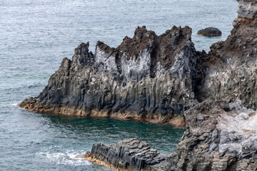 Fototapeta na wymiar Volcanic basalt columns into the Atlantic Ocean on the coastline of La Palma Island