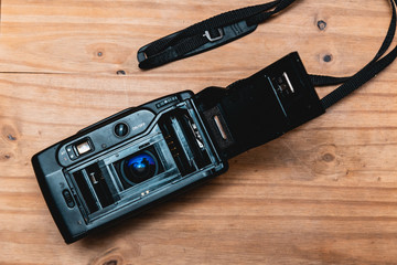 Vintage retro 35mm film camera on wooden background