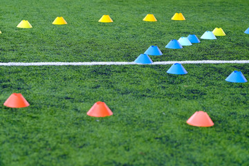 Coath arranged colorful marker cone  in  trainning class of football academy