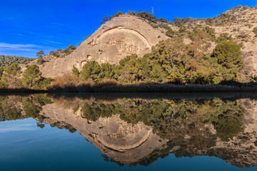 rock with portrait on king way of spain with blue sky 