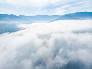 aerial view of clods and fog over mountains hills. magic time