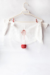 White Kitchen apron with lace and red Christmas decoration. Holiday Background Concept of Christmas and New Year.  Close up, Poster design, Copy space for Text on white paper background