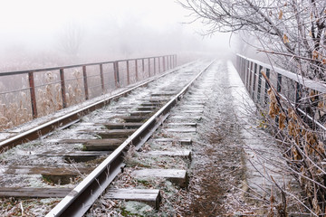 Rails in hoarfrost. Misty autumn morning.
