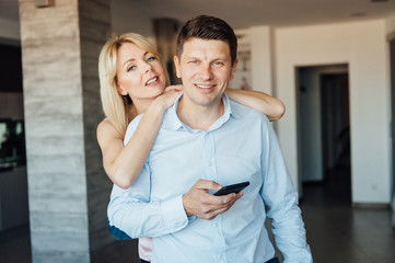 Naklejka premium Jealous woman looking at her partner chatting on the phone