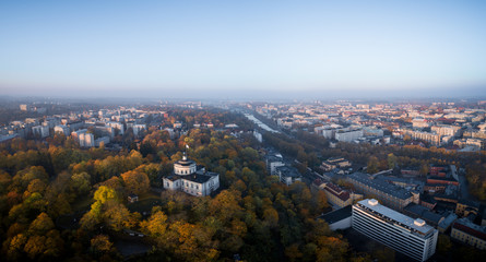 Aerial view of fall foliage on Vartiovuori Hill and Turku city center in the background in Turku, Finland