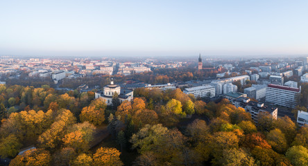 Aerial view of fall foliage on Vartiovuori Hill and Turku Cathedral in the background in Turku, Finland