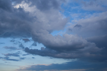 Naklejka na ściany i meble Low leaden storm clouds in the blue sky background