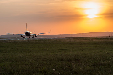 Fototapeta na wymiar Take-off plane from the airport in Varna, shot at sunset.
