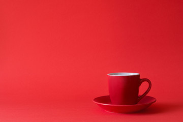 Red cups of tea or coffee on red paper background. Copy space