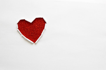 Ripped paper hole heart shaped on white paper background. Valentine's day celebration concept