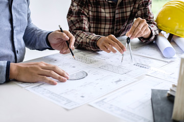 Construction engineering or architect discuss a blueprint while checking information on drawing and sketching meeting for architectural project in work site