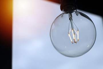 Edison lamp, vintage style bulb, background image is evening sky