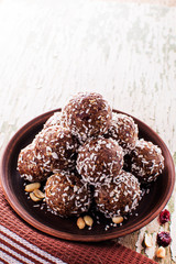 Homemade Raw Chocolate Energy Balls with Nuts, Seeds, and Coconut Chips, in a Plate