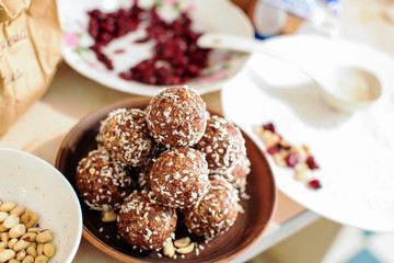 Healthy homemade paleo chocolate energy balls with oatmeal, nuts, dates and coconut flakes
