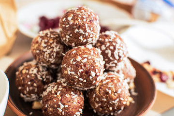Raw cocoa and coconut energy balls in a clay plate