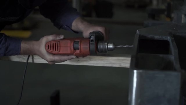 Working hands drill metal. Drill screwdriver workflow creation