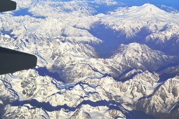 The view from the window of an airplane over the mountains of the Caucasus