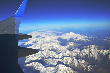 The view from the window of an airplane over the mountains of the Caucasus