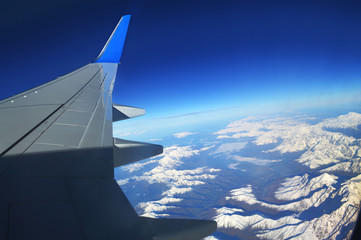 The view from the window of an airplane over the mountains of the Caucasus