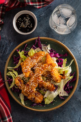 Salad with warm glazing chicken, sprinkled with sesame seeds. Chinese cuisine. Asian culture