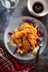 Salad with warm glazing chicken, sprinkled with sesame seeds. Chinese cuisine. Asian culture