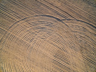 Aerial view of a plowland with harrow and tractor tires tracks, Poland