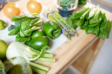 Green raw vegetables on the kitchen table