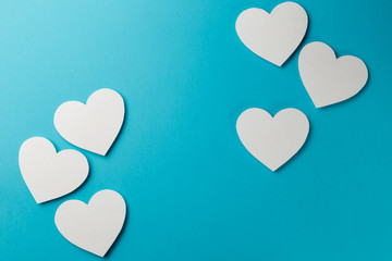 Valentine's Day postcard. Valentine's Day Background. Six valentine's paper hearts on blue background. Copy space. Top view. Flat lay. Pastel colors