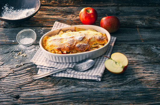 Apple Souffle Oven Dish In Casserole With Semolina Pudding On Rustic Wooden Table