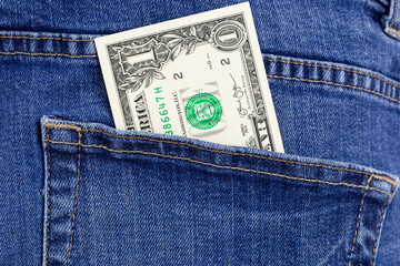 One dollar bill in jeans pocket. Money cash macro photography.