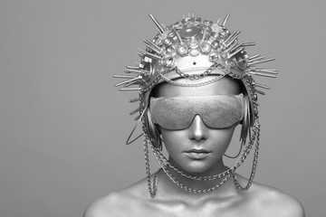 Futuristic woman in metal helmet and glasses