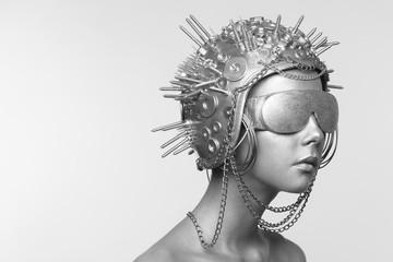Futuristic woman in metal helmet and glasses
