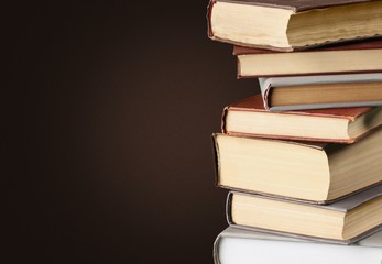 Ancient books in a row on wooden background