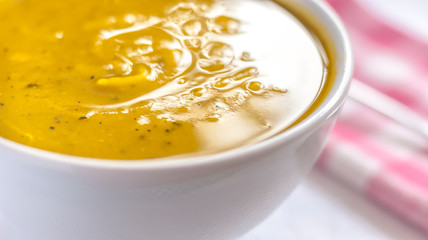 Close of white bowl with cabotia pumpkin soup