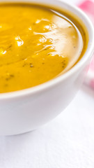 Close of white bowl with cabotia pumpkin soup