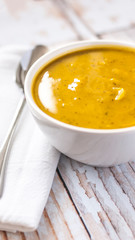 Close of white bowl with cabotia pumpkin soup