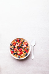 Granola Cereal bar with Strawberries and blueberries  on the Gray Background . Muesli  Breakfast. Healthy Food sweet dessert snack. Diet Nutrition Concept. Vegetarian food.Top View. Copy space