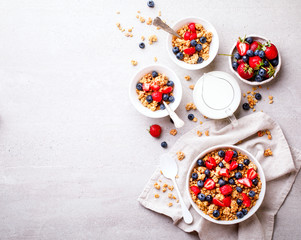 Obraz na płótnie Canvas Granola Cereal bar with Strawberries and blueberries and Milk on the Gray Background . Muesli Breakfast. Healthy Food sweet dessert snack. Diet Nutrition Concept. Flat Lay.Top View. Copy space