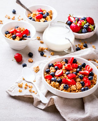 Granola Cereal bar with Strawberries and blueberries  and Milk on the Gray Background. Muesli with  berries Useful Breakfast. Healthy Food sweet dessert snack. Diet Nutrition Concept. 