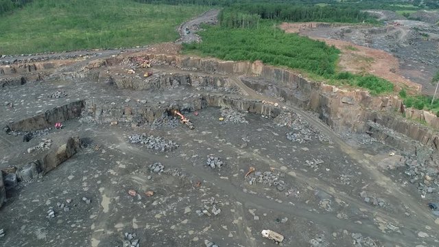 Excavator on the stone ore opencast, Loading of iron ore on very big dump-body truck, Dump truck being loaded ore on the opencast, Panorama of an open-cast mine