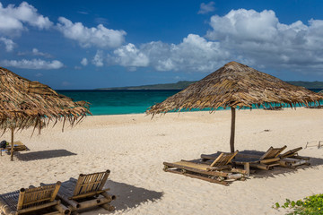 Sunbeds and umbrellas on a white sand beach