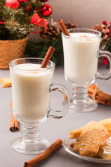 Christmas eggnog in glass mug and cinnamon.