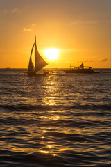 Small sailing boats at the sunset. Boracay, Philippines