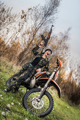 Young woman in camouflage clothes with gun