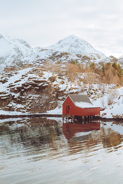 Small hut at a nearby lake with mountains in the distance